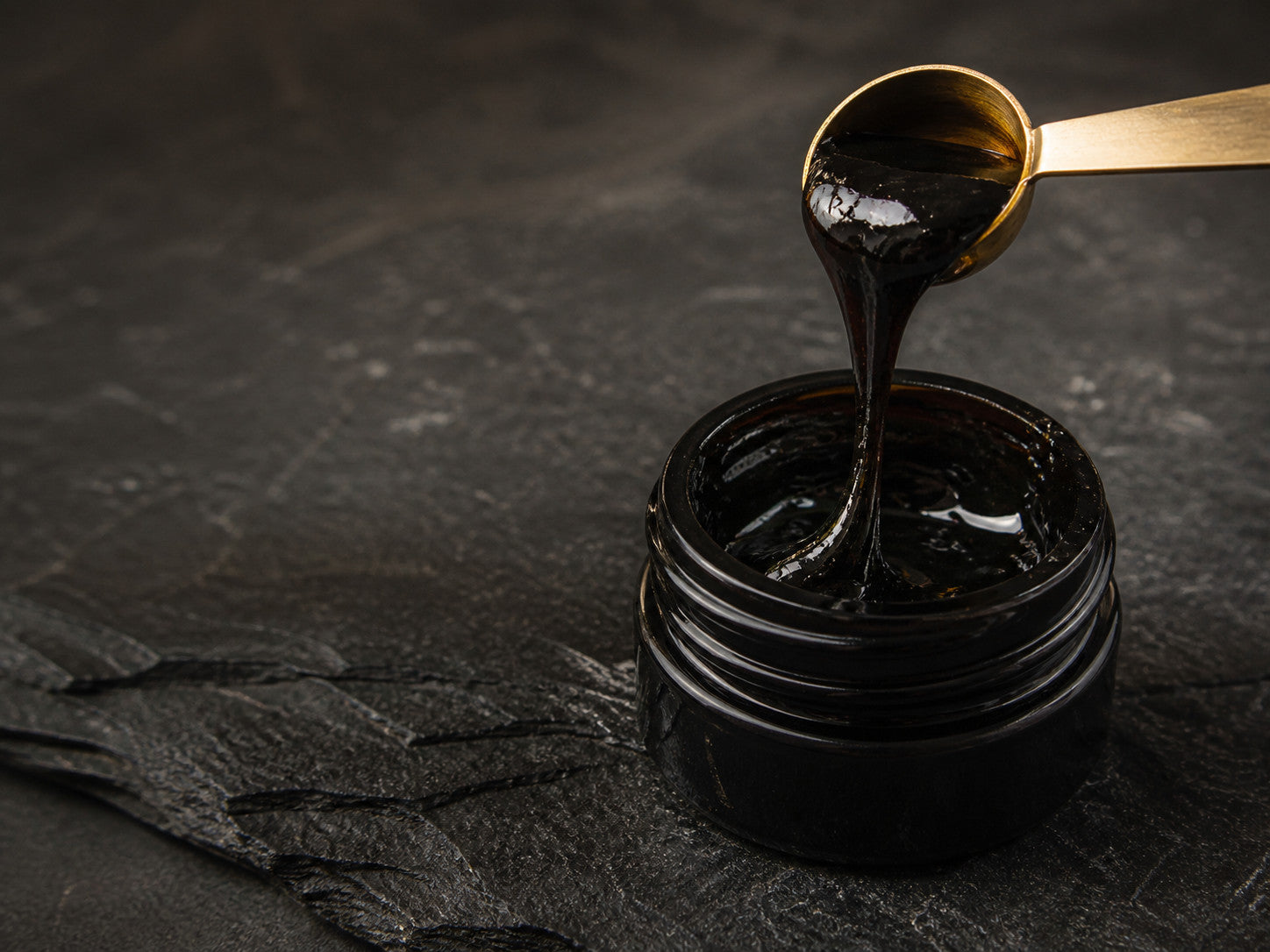 Close view of the natural glossy texture of Essencraft Shilajit Resin
